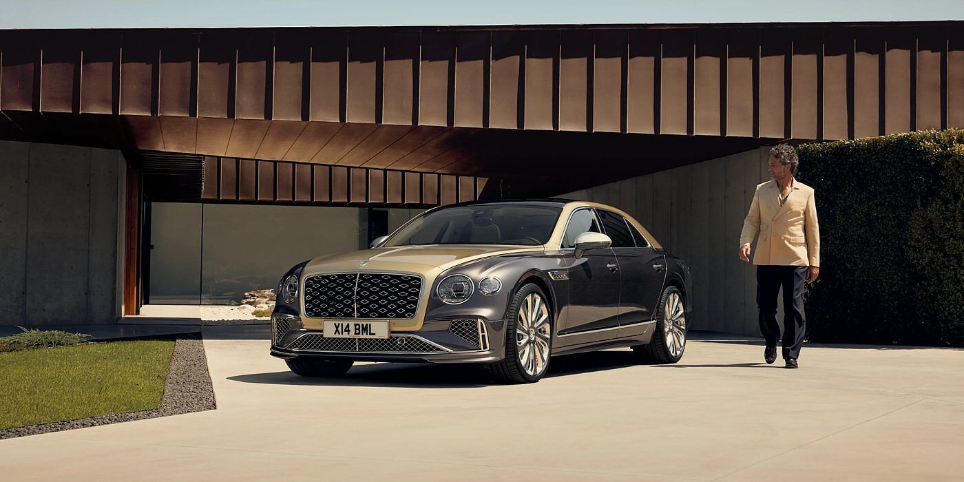 Bentley Hong Kong - Kam Lung Bentley New Flying Spur Mulliner V8 hybrid sedan front three quarters in Rose Gold over Magnetic paint, parked near modern home