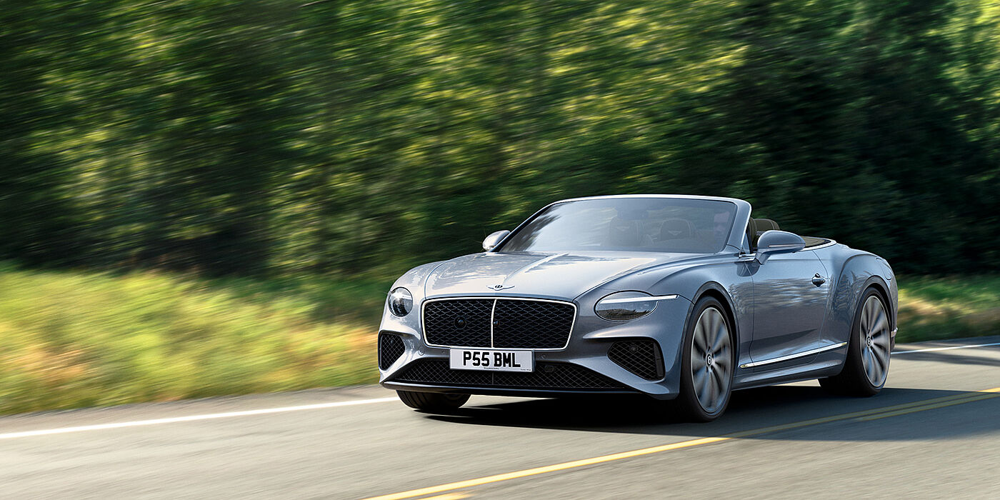 Bentley Hong Kong - Kam Lung New Bentley Continental GTC convertible front view in Silverlake paint with 22 inch ten spoke wheels, driving dynamically on a country road