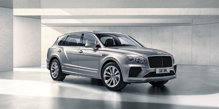 Bentley Hong Kong - Kam Lung Bentley Bentayga Extended Wheelbase SUV front three quarter in Moonbeam paint with a grey background
