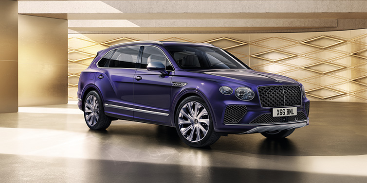 Bentley Hong Kong - Kam Lung Bentley Bentayga Extended Wheelbase Mulliner SUV front three quarter in Tanzanite Purple paint with a gold patterned background
