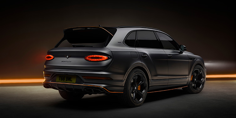 Bentley Hong Kong - Kam Lung Bentley Bentayga S Black Edition SUV rear three quarter in Anthracite Satin paint against a dark red and yellow background
