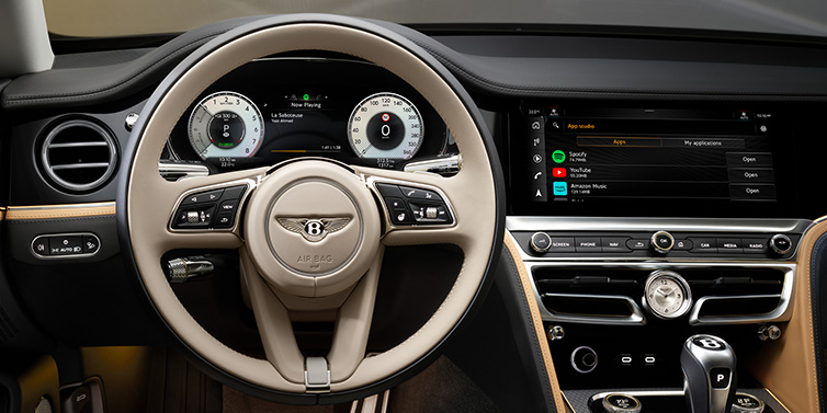 Bentley Hong Kong - Kam Lung Bentley Flying Spur Mulliner sedan front interior detail of steering wheel and driver screens surrounded by Linen and Beluga black hides