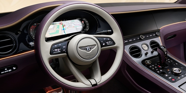 Bentley Hong Kong - Kam Lung Bentley Continental GT Mulliner coupe front interior showing steering wheel and drivers screens surrounded by Linen and Damson hides and Grand Black veneer